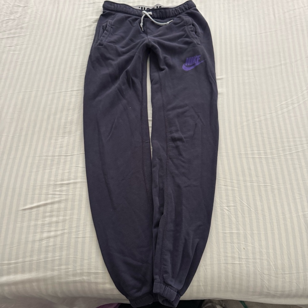 Navy Nike joggers with purple logo